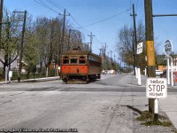Following up on <a href=http://www.railpictures.ca/?attachment_id=46911>Michael Klauck's recent posting,</a> here we see NS&T interurban car 83 approaching the intersection of Main and Elm Streets southbound for <a href=http://www.railpictures.ca/?attachment_id=44470>Port Colborne station.</a>  Note the yellow markings on posts (were these car stops for passengers?), the Cities Service station - now an ESSO as Michael notes - and the vintage automobiles.<br><br>NS&T car 83 was built in 1924 by the NS&T for the Toronto Suburban Railway as their 107, serving there until shutdown on August 15, 1931.  It would be moved back to the NS&T in 1935 and renumbered 83, painted in vermillion and cream as seen above.  By March 1956, 83, along with other equipment, would be painted into CNR green, NS&T being under CNR Electric Lines.  Going by this date this undated slide was shot in spring 1955 or earlier.<br><br><i>Original Photographer Unknown, Jacob Patterson Collection Slide.</i>