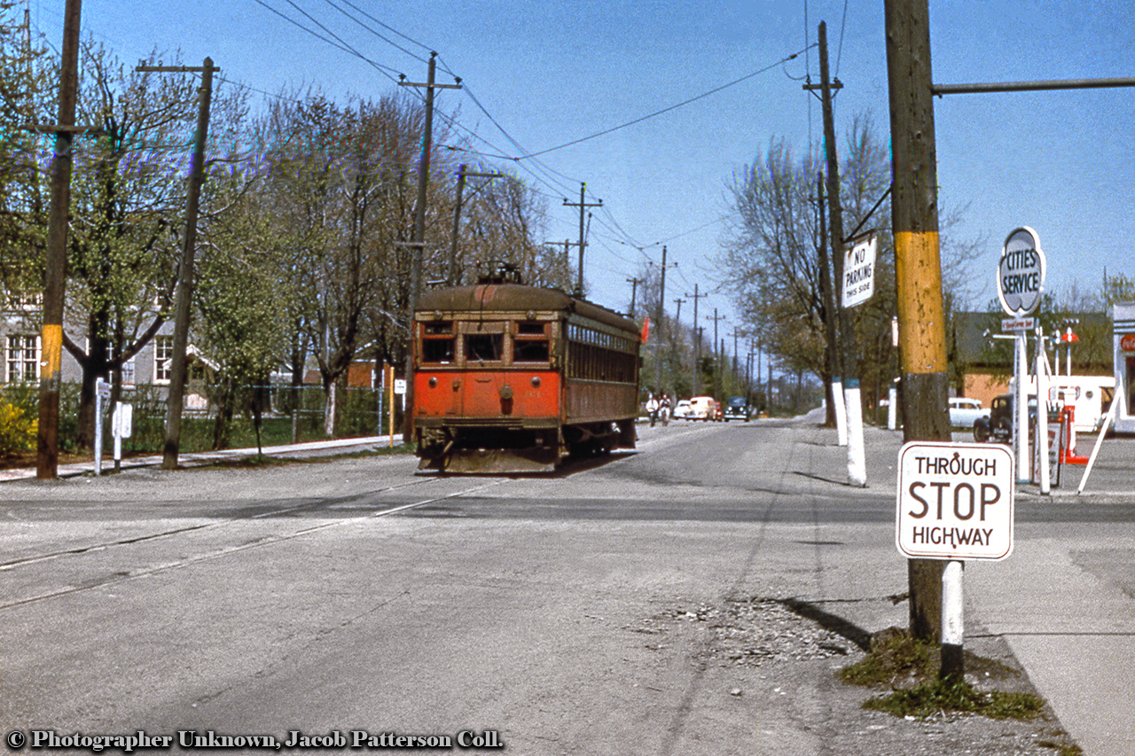 Following up on Michael Klauck's recent posting, here we see NS&T interurban car 83 approaching the intersection of Main and Elm Streets southbound for Port Colborne station.  Note the yellow markings on posts (were these car stops for passengers?), the Cities Service station - now an ESSO as Michael notes - and the vintage automobiles.NS&T car 83 was built in 1924 by the NS&T for the Toronto Suburban Railway as their 107, serving there until shutdown on August 15, 1931.  It would be moved back to the NS&T in 1935 and renumbered 83, painted in vermillion and cream as seen above.  By March 1956, 83, along with other equipment, would be painted into CNR green, NS&T being under CNR Electric Lines.  Going by this date this undated slide was shot in spring 1955 or earlier.Original Photographer Unknown, Jacob Patterson Collection Slide.