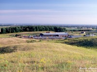 The late Keith Hansen covered a lot of territory east of Toronto, including many of the CN and CP branchlines in their waning years. Operation on the CP's Havelock Sub were included, home to some of the last branchline passenger runs in Southern Ontario served by Budd RDC cars (before the January 1990 service cuts nixed them). Here, a VIA RDC-2 and RDC-1 (likely units 6224 and 6121) make their way eastbound through Raglan, Ontario on Toronto-Havelock train #192 after crossing Simcoe Street North (out of frame to the right). This view is from the Purple Woods Conservation Area, looking south to Raglan, and beyond to Oshawa and Lake Ontario off in the distance.
<br><br>
<i>Keith Hansen photo, Dan Dell'Unto slide collection</i>.