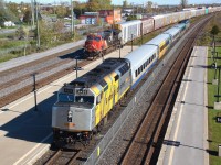 A perfect late autumn day in Belleville, Ontario where the rail paint schemes vary like the leaves, but we enjoy them all. VIA Rail train 63 is pulling in to the station just a few minutes behind schedule. 63 is lead by F40PH-2, 6420 and trailing is P42DC, 901. Waiting to proceed out of the yard with a long string of auto racks is ES44AC, CN 3090, looking a little worse for wear.