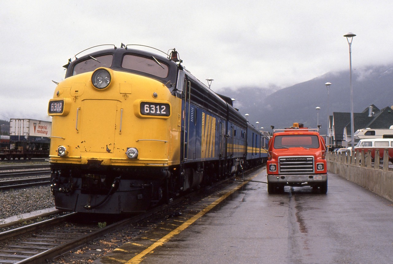 JASPER JUMP OFF-During its 40 minute station stop at Jasper, the eastbound Super Continental # 4 gets a full servicing and crew change while the photographer and his fiancée jump off to quickly explore this beautiful gem in the Rockies and capture the 'B' unit getting topped up by a CN fuel truck on September 27, 1988. Now on the return trip to their native Newfoundland after a marriage proposal on the west bound Canadian # 1 on September 24, they chose the 2 night northern route back to Winnipeg to connect with the eastbound Canadian # 2 for the run into Toronto for a few days. Wanting to ride as many different VIA routes as possible on their month long journey, they were waitlisted for a sleeper for nearly six months and learned just weeks before departure that space had opened up, such was the demand at the time for # 4.