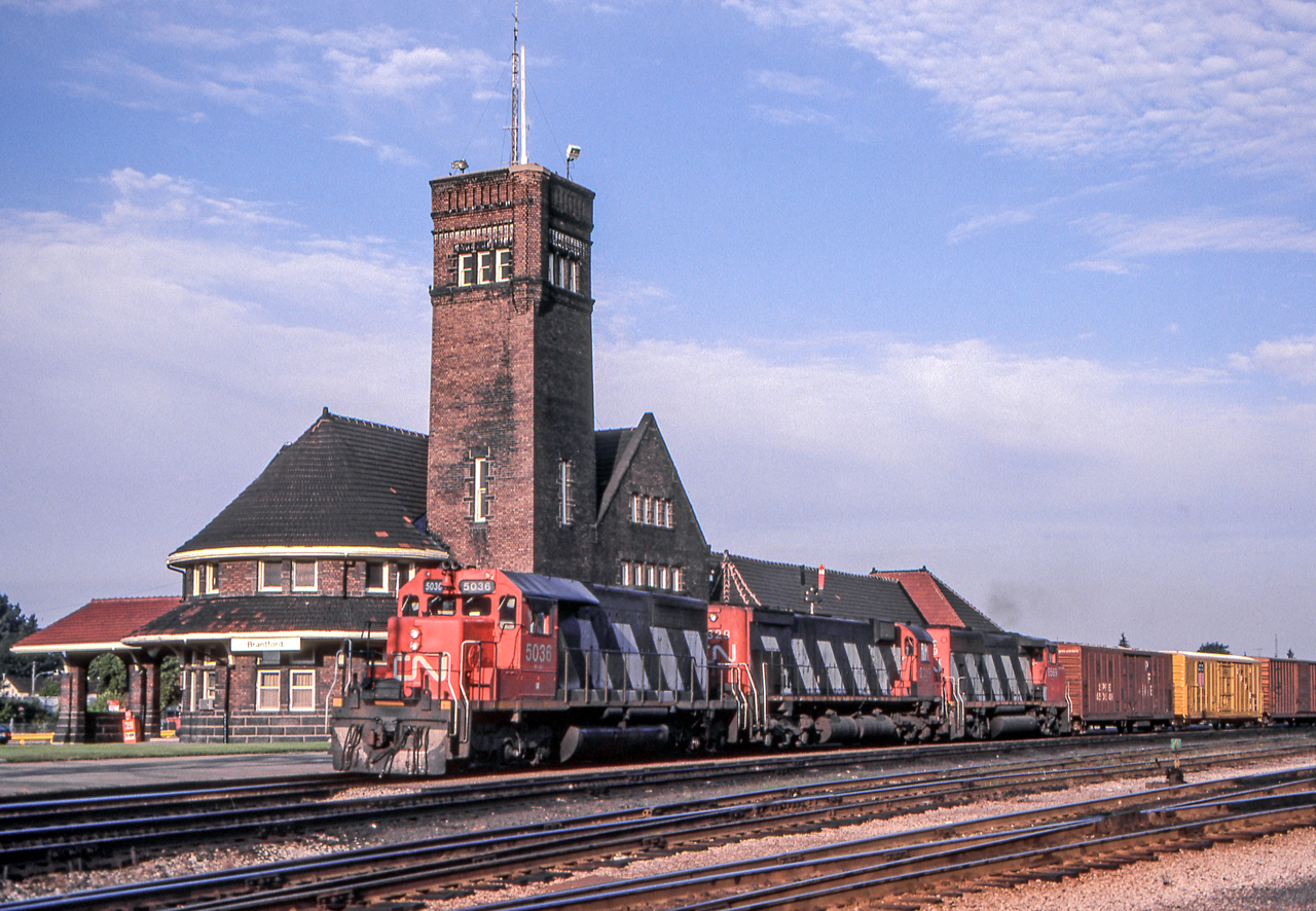 CN 5036 is passing the VIA station in Brantford, Ontario on August 14, 1982.
