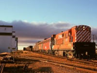 On the cold morning of Thursday 1974-10-03 at Aldersyde, AB, train Second 75 with FM/CLC H16-44 8720 leading and GMD F7B units 4433 and 4444 trailing has paused at the depot (the mast seen above the first boxcar is for the radio at the depot) for a meet with southward train 992.  No. 75 was a daily train from Lethbridge via the Aldersyde sub. to a junction with the Macleod sub. (near the tail end of this train) and onward to Alyth Yard in Calgary.  Now, the Macleod sub south of Aldersyde is history except for a short spur, and north of here is a continuation of the Aldersyde sub.