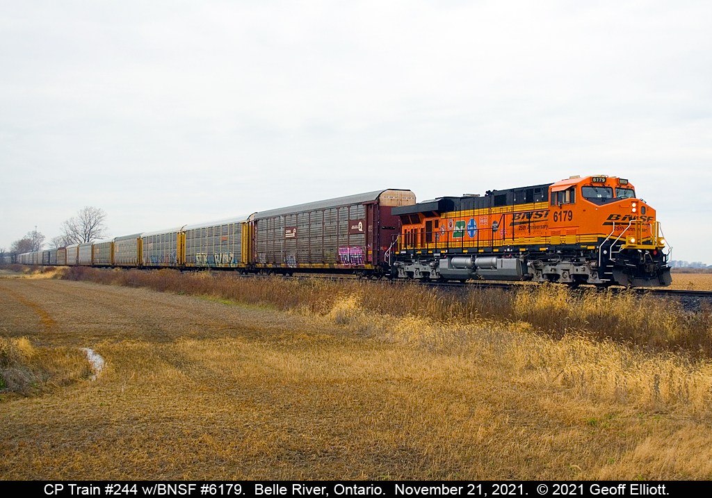 Dull day enlightenment....  Had heard that CP 244 had a solo BNSF GE on it, but it was an ugly morning, so I wasn't thinking it would be worth the time.  About 10 minutes before 244 arrived in Belle River to meet westbound CP train #141, I got a report that BNSF 6179 was the lone unit on 244....  Wait...  That's a 'sticker' unit...  So I decided that despite it being an ugly day, it might be worth heading out for a few minutes.  So here you see BNSF 6179, the 25th Anniversary unit, as it approaches Strong Road just east of Belle River, Ontario after having waited for 141 to pass.  Funny what can brighten up a dull day sometimes.......