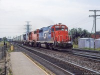 CN/GTW Trailer On Flat Car aka "Laser" train 238 is eastbound along the Oakville Sub just taking the switch to the Halton sub at Burlington West, bound for <a href=http://www.railpictures.ca/?attachment_id=44628>Brampton Intermodal Terminal.</a>  Power today includes a trio of former Detroit Toledo & Ironton GP40-2 locomotives, renumbered into the Grand Trunk Western series after the DT&I came under GTW control in the early 1980s.  6417/6418/6419 were originally DT&I 417/418/419.


