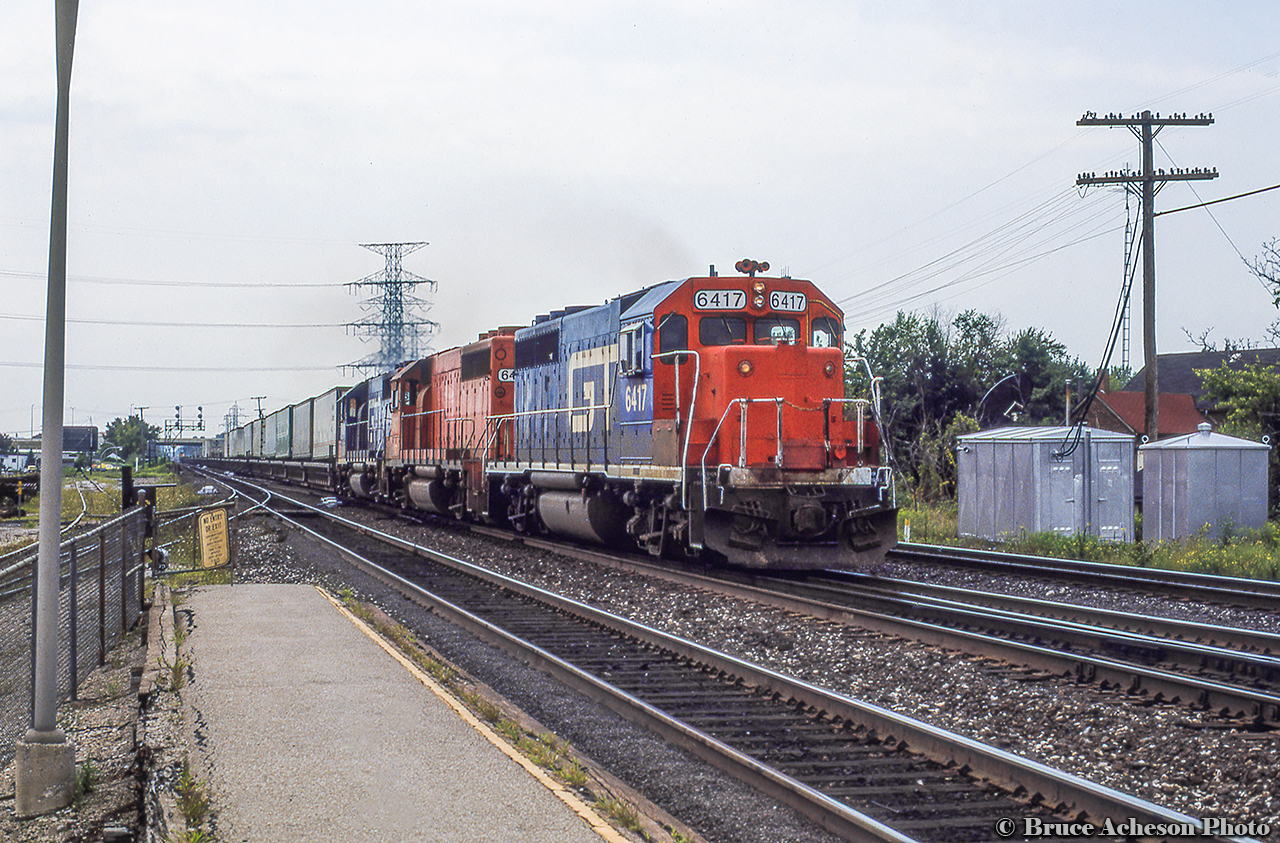 CN/GTW Trailer On Flat Car aka "Laser" train 238 is eastbound along the Oakville Sub just taking the switch to the Halton sub at Burlington West, bound for Brampton Intermodal Terminal.  Power today includes a trio of former Detroit Toledo & Ironton GP40-2 locomotives, renumbered into the Grand Trunk Western series after the DT&I came under GTW control in the early 1980s.  6417/6418/6419 were originally DT&I 417/418/419.