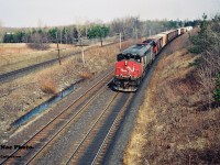 CN 381 is seen westbound as it wastes no time heading for Windsor approaching the famed Denfield Road bridge at Hyde Park with CN 2104 and 5041.
