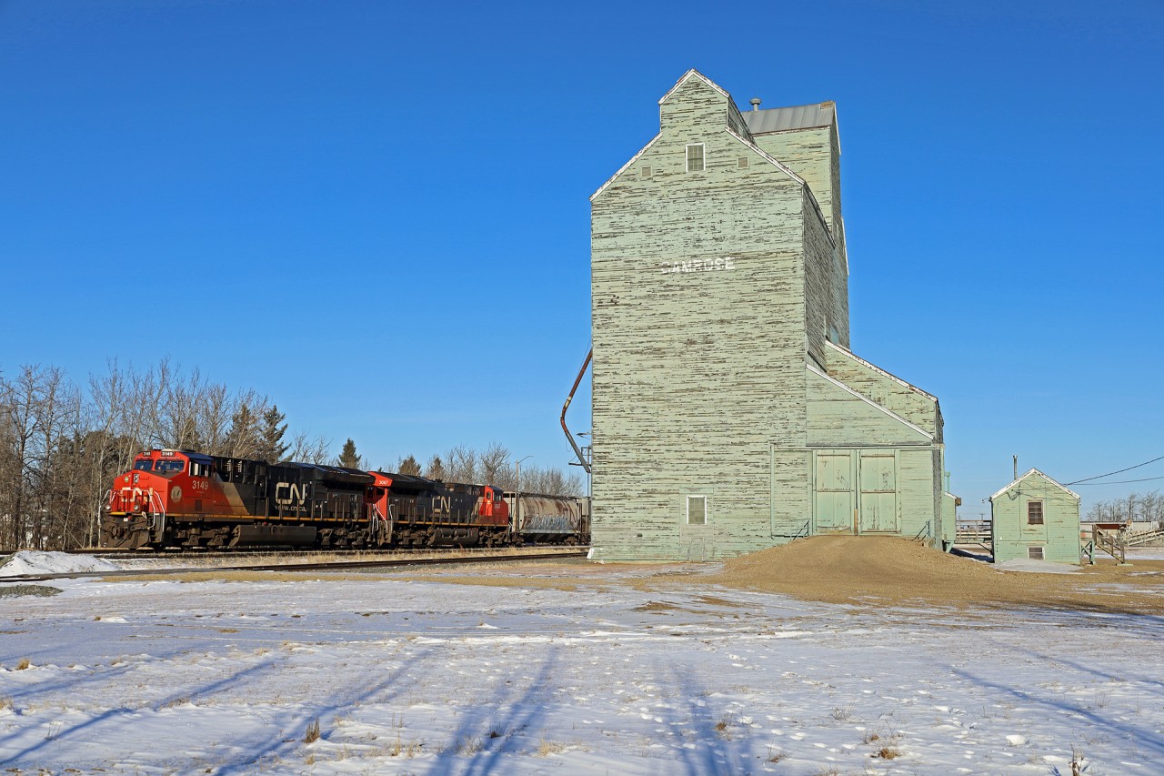 Edmonton to Trochu G 81451 24 rolls past the wooden elevator in Camrose, Alberta