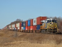 Q 19651 27 rolls through Deville, Alberta with CN 3946 on the point.