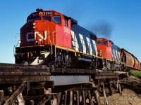 As the units pass over the trestle at mile 18.45, the engineer throttles them up a notch to climb the hill from the Sturgeon river. Beneath the trestle is township road 564, which takes traffic out to Hwy.28. In 2 more miles the mixed will pass through the hamlet of Coronado. The tail end was full with 2 baggage cars, 2 coach cars and a caboose.