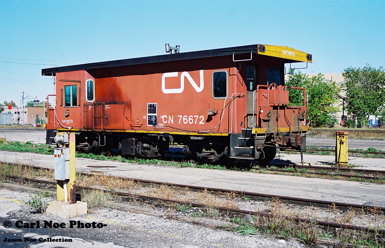 In early morning light, CN transfer van 76672 is viewed sitting at the car repair area of CN’s London yard. This caboose had sat here from late summer until early fall that year before departing to an unknown destination.