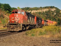 As of November 3, 2021; CN had assigned GP40-2L(W)'s 9416, 9449 and 9639 to Kitchener, which were used daily on the three assigned locals from the terminal. Twenty-five years earlier these units were the backbone of the company’s mainline power and were rarely used in local service.
<br>
A fitting example shows CN 145 rolling beneath the famed Dundas Peak with GP40-2L(W)’s 9446 and 9638 bracketing still new SD75I 5636 as they head westbound to Sarnia and at the time through the newly constructed tunnel to the US. 

