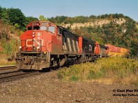 As of November 3, 2021; CN had assigned GP40-2L(W)'s 9416, 9449 and 9639 to Kitchener, which were used daily on the three assigned locals from the terminal. Twenty-five years earlier these units were the backbone of the company’s mainline power and were rarely used in local service.
<br>
A fitting example shows CN 145 rolling beneath the famed Dundas Peak with GP40-2L(W)’s 9446 and 9638 bracketing still new SD75I 5636 as they head westbound to Sarnia and at the time through the newly constructed tunnel to the US. 
