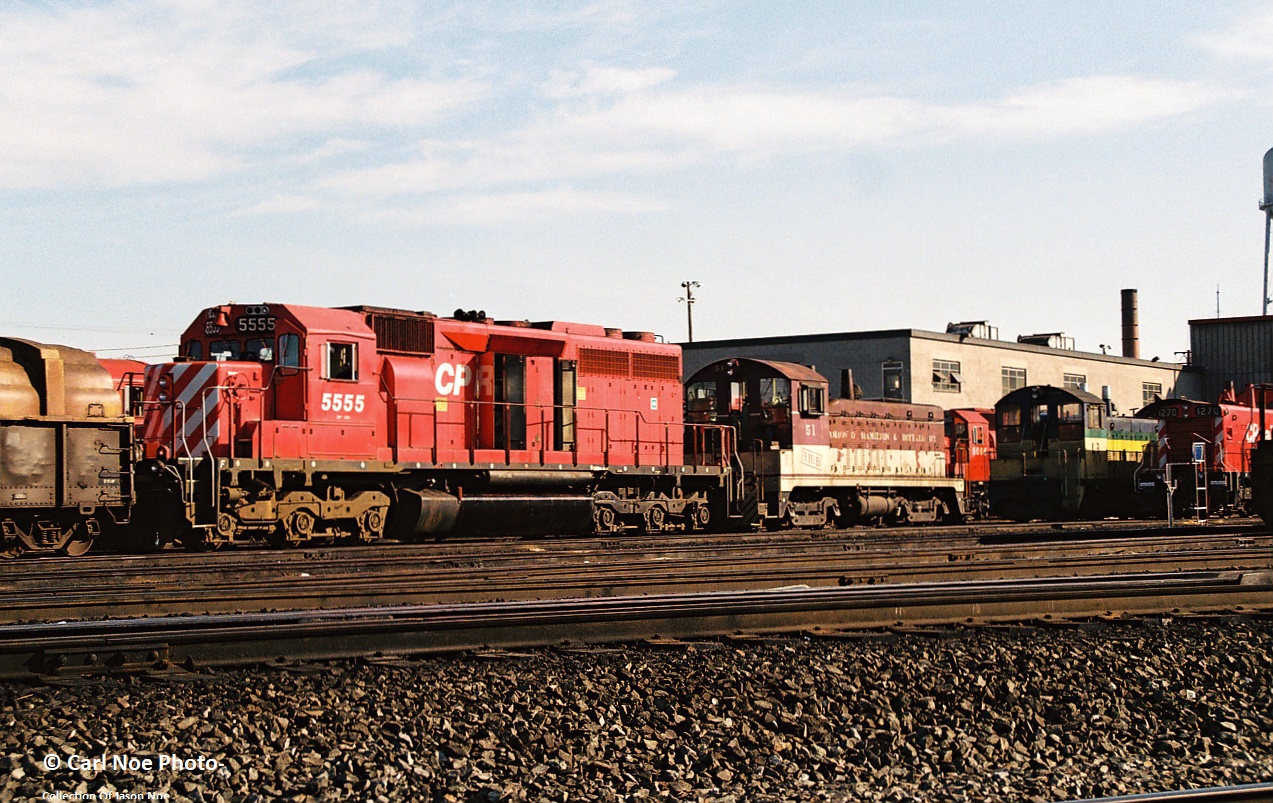 In early morning light, CP SD40 5555 and former TH&B NW2 51, along with former Port Stanley Terminal Rail SW9 L3 share shop tracks at CP’s Agincourt Yard in Toronto, Ontario. Both switchers were part of the first unit’s ever owned by the Ontario Southland Railway, (OSR) which at the time according to the 1995 Trackside Guide was only in the locomotive and car leasing/storage business.