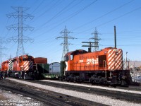CP Rail 7022, one of the regular old Alco S2 switchers assigned to downtown Toronto's John Street Roundhouse for Toronto-area industrial switching, works the Obico Industrial job on the Canpa Subdivision near the south end of Obico Yard. Sitting nearby are CP SD40's 5554 and 5507, today's power for the Toronto-Hamilton "Starlight".<br><br>Behind 7022, a spur leads into Ontario Hydro's sprawling property along the Canpa Sub on the west side of Kipling, north of Queen Street and south of the Manby Transformer Station (see the far left side of this <a href=http://jpeg2000.eloquent-systems.com/toronto.html?image=ser12/s0012_fl1968_it0042.jp2><b>1968 aerial</b></a>). Most if not all of the old HEPC property has since been sold off, and the rail spurs inside the grounds and to the nearby transformer station have all been removed.<br><br><i>Peter Jobe photo, Dan Dell'Unto collection slide.</i>