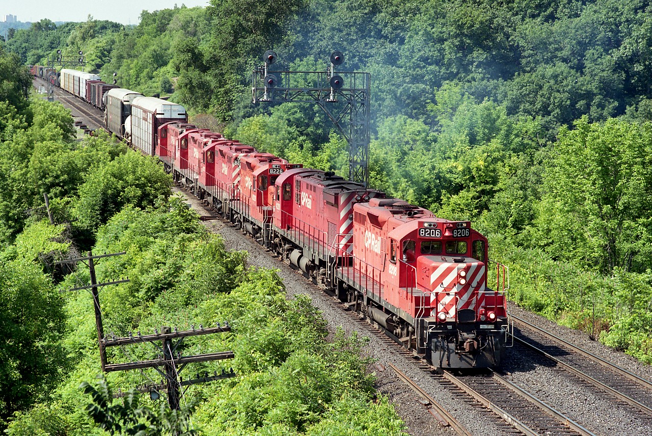 Awh!!!  The Good Old Days already....for me.  I used to love seeing stuff like this....  CP exercising their trackage rights over the CN Oakville back then. Not only did it make for more traffic as seen from the 'railfans walkbridge', it made for some interesting head end power combinations as well.  CP 8206, 4229, 8226, 8237, 8211 and 1624. All units now off the CP roster. Interesting to note that the trailing unit was sold to Aspen Crossing Railway (Alberta) in 2015 and is still active there; as shown in a photo posted on RP a couple of days ago.