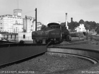 Another view of Canadian Pacific Railway 6275 (a U3e class 0-6-0 build by CP's Angus Shops in 1912) during its final year serving as Goderich's regular steam switching power, parked by the turntable near the roundhouse (front view <a href=http://www.railpictures.ca/?attachment_id=23837><b>here</b></a>). In the background is the yard lead to the mainline, a few sidings, and some industries including the nearby grain elevator and silos.<br><br>Diesel-powered <a href=http://www.railpictures.ca/?attachment_id=29867><b>CP DT2 17</b></a> replaced 6275 as Goderich's regular switching power. The roundhouse was demolished, but the turntable survived well into the <a href=http://www.railpictures.ca/?attachment_id=31222><b>diesel era</b></a>.