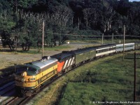 Following up on <a href=http://www.railpictures.ca/?attachment_id=47234>Dan's recent post,</a> here is another shot of the ONR/CNR overnight sleeper "Northland" led by ONR FP7 1510 and CN FPA-4 6779 alongside Rosedale siding about to duck under the Don Valley Parkway on/off ramp near Bayview Avenue (in background) just north of Bloor.  As seen in the images linked below, the "North;and" often had interesting consists as it was made up of equipment from both ONR and CN, and later ONR and VIA.  Today's consist includes an ONR baggage car and two CN cars bracketing an ONR car in the fairly unique "Progressive Green" scheme.  This paint scheme dates the slide to about 1970 or slightly earlier.<br><br>Ontario Northland introduced it's Progressive Green scheme in 1966, having five locomotives painted in the scheme.  These include ONR FP7s 1502 and 1517 <a href=http://www.railpictures.ca/?attachment_id=33549>(seen here at Allandale), </a> FP7 1521 <a href=http://www.railpictures.ca/?attachment_id=38638>(seen here at Oakville/Burlington),</a> RS3 1311 <a href=http://www.railpictures.ca/?attachment_id=36530>(seen here at North Bay),</a> and S-2 1200 <a href=http://www.trainweb.org/oldtimetrains/photos/onr/1200.jpg>(seen here at North Bay).</a>  The FP7s were repainted in about six years, however the switchers carried the scheme until retirement.  Freight equipment carried this scheme, and it would appear some passenger equipment did as well.  The shields carried on the side of the FP7s appears twice on each side of the third car in this train.  A close up of lunch/cafe car <i>"Meechim"</i> in this scheme can be <a href=http://www.trainweb.org/oldtimetrains/photos/onr/Meechim.jpg>found here</a> for comparison.<br><br>More "Northland":<br><a href=http://www.railpictures.ca/?attachment_id=7278>1977 near Don Mills Road</a> by Steve Danko.<br><a href=http://www.railpictures.ca/?attachment_id=29508>1978 by Queen Street</a> by David Parker.<br><br><i>Original Photographer Unknown, Al Chione Duplicate, Jacob Patterson Collection Slide.</i>