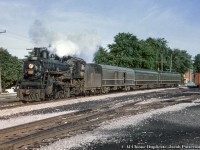 Due into Stratford at 0705h, train 28 from Goderich is seen curving down the last piece of the Goderich Sub alongside St. David Street (house at left being number 57) and, out of sight to the right, the <a href=http://www.railpictures.ca/?attachment_id=15165>CNr Stratford shops</a> (note the sign and switchstand in both images).  In just a moment, 28 will pull into <a href=http://www.railpictures.ca/?attachment_id=46642>track one</a> and 5567 will head for the roundhouse to be serviced.  A heavier engine, likely a Mountain type, will take control from Stratford to Toronto as the consist will grow with two coaches tacked on the rear.  28 will depart for Toronto at 0717h, arriving at 0950h.<br><br>CNR 5567, a K-3-a Pacific built by the Grand Trunk in 1912 as P4 class number 231.  It received its renumbering/classification in 1923, and was scrapped in May 1958.  As such, this undated slide would likely have been taken in 1957 or earlier.<br><br><i>Original Photographer Unknown, Al Chione Duplicate, Jacob Patterson Collection Slide.</i>