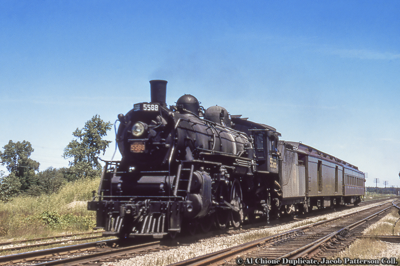 Sarnia-bound train 621, with a scheduled arrival at Komoka at 1235h, coasts towards the station.  Departing London at 1220h, it is scheduled to arrive at Sarnia at 1355h.  It will return to London later that afternoon as train 620.CNR 5588, built as Grand Trunk 213 in 1911, renumbered/classed as CNR K-3-b 5588 in 1923, retired 1961 and placed on display at Windsor.Original Photographer Unknown, Al Chione Duplicate, Jacob Patterson Collection Slide.