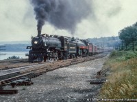 A double-headed excursion behind CPR G5c Pacific 1271 and H1c Royal Hudson 2839 is seen departing Hamilton taking the connecting track at Hamilton Junction onto the CNR Oakville Subdivision headed for Toronto.  The annual NRHS Buffalo Convention was held in Toronto at the end of August 1958 featuring a two-day set of excursions, one over the CPR and one over the CNR the following day. The CPR excursion ran Toronto - <a href=http://www.railpictures.ca/?attachment_id=44667>Guelph Junction</a> - Hamilton and return via Oakville.  An excursion on the CNR <a href=http://www.railpictures.ca/?attachment_id=46811>ran the next day.</a><br><br>By this time only four steam locomotives (including the two pictured) were still active out of John Street, 1271 (last G5c Pacific, built by CLC April 1947), Royal Hudson 2839 (H1c, MLW 1937), 1265 (G5c, CLC 1947), and <a href=http://www.railpictures.ca/?attachment_id=40263>2399 (G3g, CLC 1942),</a> all but one of one of which would be retired and scrapped. The survivor, CPR 2839, is now <a href=https://images-wixmp-ed30a86b8c4ca887773594c2.wixmp.com/f/df6d73c0-1cac-4eb5-84b7-888fbe8c781d/ddb2ux2-85c8ef86-6f86-4d66-bfeb-7b519aeb3f62.jpg/v1/fill/w_1920,h_1294,q_75,strp/cpr_h1c_royal_hudson_2839_in_california_1_by_rlkitterman_ddb2ux2-fullview.jpg?token=eyJ0eXAiOiJKV1QiLCJhbGciOiJIUzI1NiJ9.eyJzdWIiOiJ1cm46YXBwOiIsImlzcyI6InVybjphcHA6Iiwib2JqIjpbW3siaGVpZ2h0IjoiPD0xMjk0IiwicGF0aCI6IlwvZlwvZGY2ZDczYzAtMWNhYy00ZWI1LTg0YjctODg4ZmJlOGM3ODFkXC9kZGIydXgyLTg1YzhlZjg2LTZmODYtNGQ2Ni1iZmViLTdiNTE5YWViM2Y2Mi5qcGciLCJ3aWR0aCI6Ijw9MTkyMCJ9XV0sImF1ZCI6WyJ1cm46c2VydmljZTppbWFnZS5vcGVyYXRpb25zIl19.n2-zyXNz7m3i8kOoNznWzZ_m10oS-fBeigMnp8lSkRA>on display at Sylmar California</a> as part of the Nethercutt Collection. Thanks to Ray Kennedy and George Roth for information.<br><br>Original Photographer Unknown, Al Chione Duplicate, Jacob Patterson Collection Slide.</i>