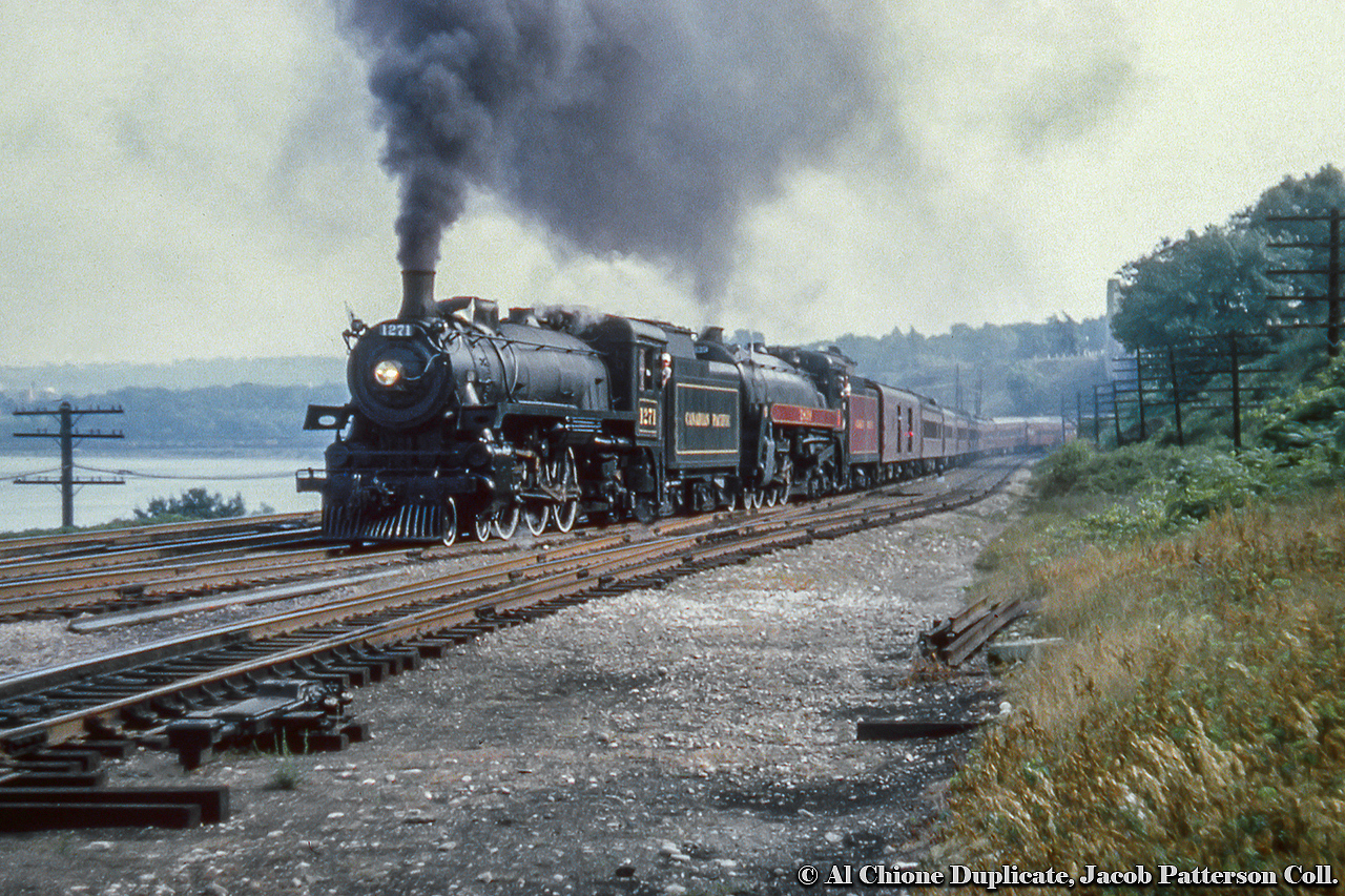 A double-headed excursion behind CPR G5c Pacific 1271 and H1c Royal Hudson 2839 is seen departing Hamilton taking the connecting track at Hamilton Junction onto the CNR Oakville Subdivision headed for Toronto.  The annual NRHS Buffalo Convention was held in Toronto at the end of August 1958 featuring a two-day set of excursions, one over the CPR and one over the CNR the following day. The CPR excursion ran Toronto - Guelph Junction - Hamilton and return via Oakville.  An excursion on the CNR ran the next day.By this time only four steam locomotives (including the two pictured) were still active out of John Street, 1271 (last G5c Pacific, built by CLC April 1947), Royal Hudson 2839 (H1c, MLW 1937), 1265 (G5c, CLC 1947), and 2399 (G3g, CLC 1942), all but one of one of which would be retired and scrapped. The survivor, CPR 2839, is now on display at Sylmar California as part of the Nethercutt Collection. Thanks to Ray Kennedy and George Roth for information.Original Photographer Unknown, Al Chione Duplicate, Jacob Patterson Collection Slide.