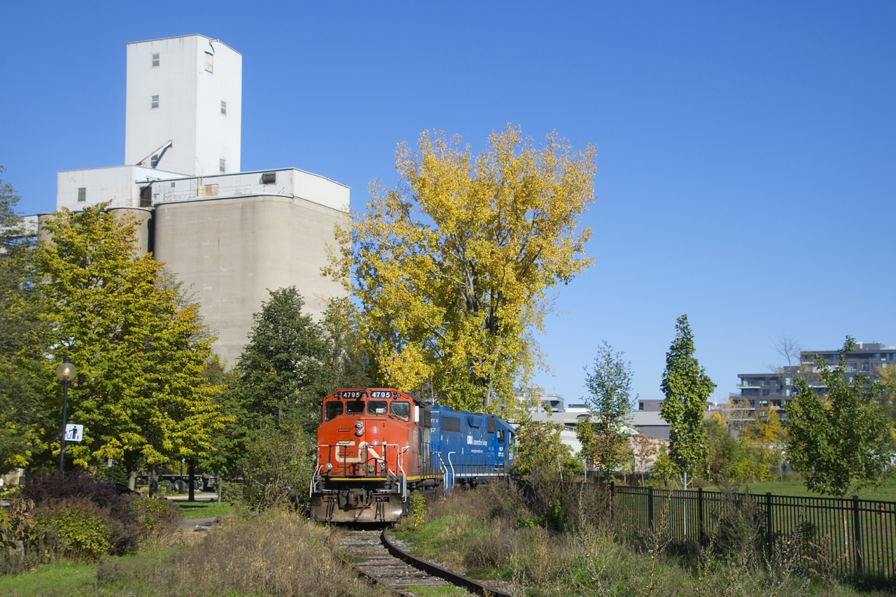 The Pointe St-Charles Switcher is shoving loaded grain cars into Ardent Mills.