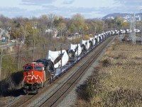 CN X319 is comprised of CN 3137 and 72 windmill blades as it approaches MP 14 of CN's Kingston Sub.