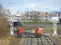 CN 305's trailing unit (CN 3822, at left) is being brought to Taschereau Yard by in the inbound crew, as the outbound crew prepares to back the leader (CN 2830, at right) back to its train.