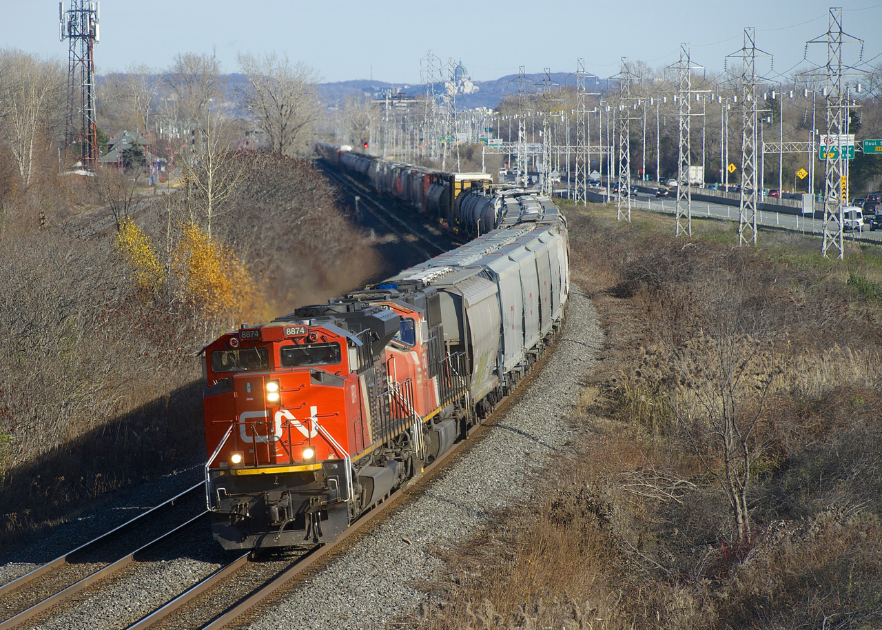 An SD70M-2 and an SD75I (CN 8874 & CN 5762) lead a CN 377 with grain empties up front through Beaconsfield.