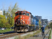 The conductor is about to dismount CN 4795 to flag Charlevoix Street as the Pointe St-Charles Switcher leaves the East Side Canal Bank Spur light power.