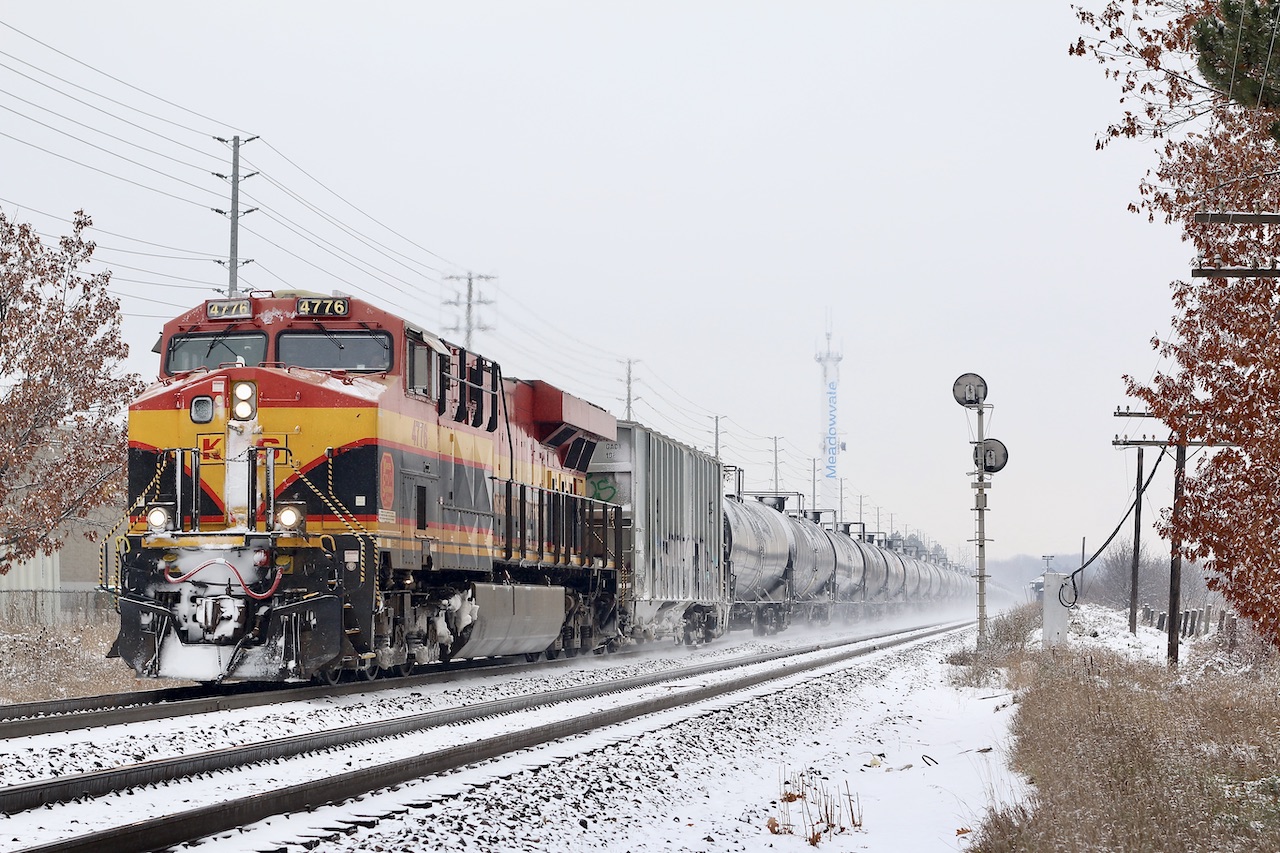 A sign of things to come? Maybe. This was definitely worth the wait, as there were some kind of issues along the way east of Wolverton. CP ethanol train 650 with a KCS leader is seen passing the clashing seasons at Meadowvale, as autumn leaves still cling to the snow covered trees. The old city water tower base, now a cell tower can be seen in the distance, while the older searchlight signal in the foreground still remains amongst a subdivision full of newer LED signals.