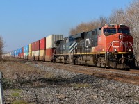  A hot intermodal eastbound is racing to the end of what was once a four track section of the line. Today the south service track here is history and the north service sees occasional use as needed. The old crossing activation switch is still intact for a track that no longer exists. Out of view behind me is the old searchlight signal bridges still spanning a four track space. The BC Rail Dash-9 trailing proved to be the catch this day as far as motive power went, with VIA trains outnumbering CN freights.