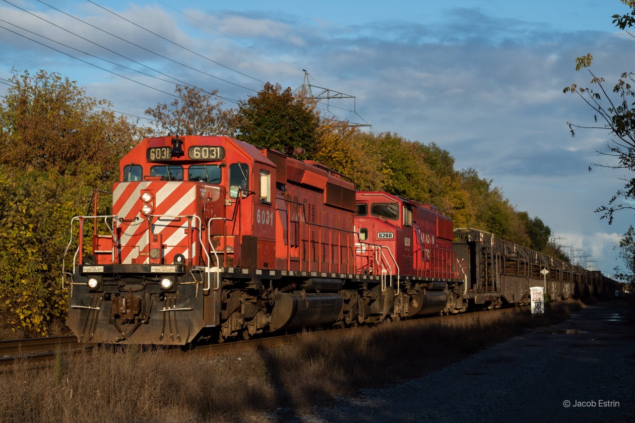 CP 6031 and 6260 lead a loaded CWR West approaching the signals at Bartlett where they will have to stop and wait for 9-112 to clear the switch onto the Mactier.