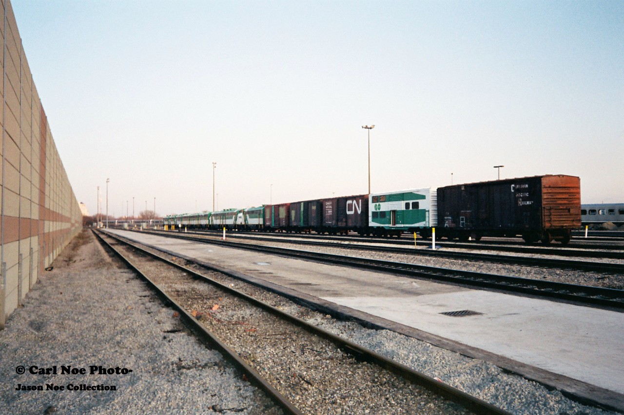 A GO Transit deadline of various locomotives and rolling stock is seen at Willowbrook Yard in Mimico, Ontario. Among the retired F’s, B-units and GP40’s was CN 561747, which was a conversion of a 40 foot boxcar painted in GO Transit colors only on the one side. For a better view of this car please see; http://www.railpictures.ca/?attachment_id=40492