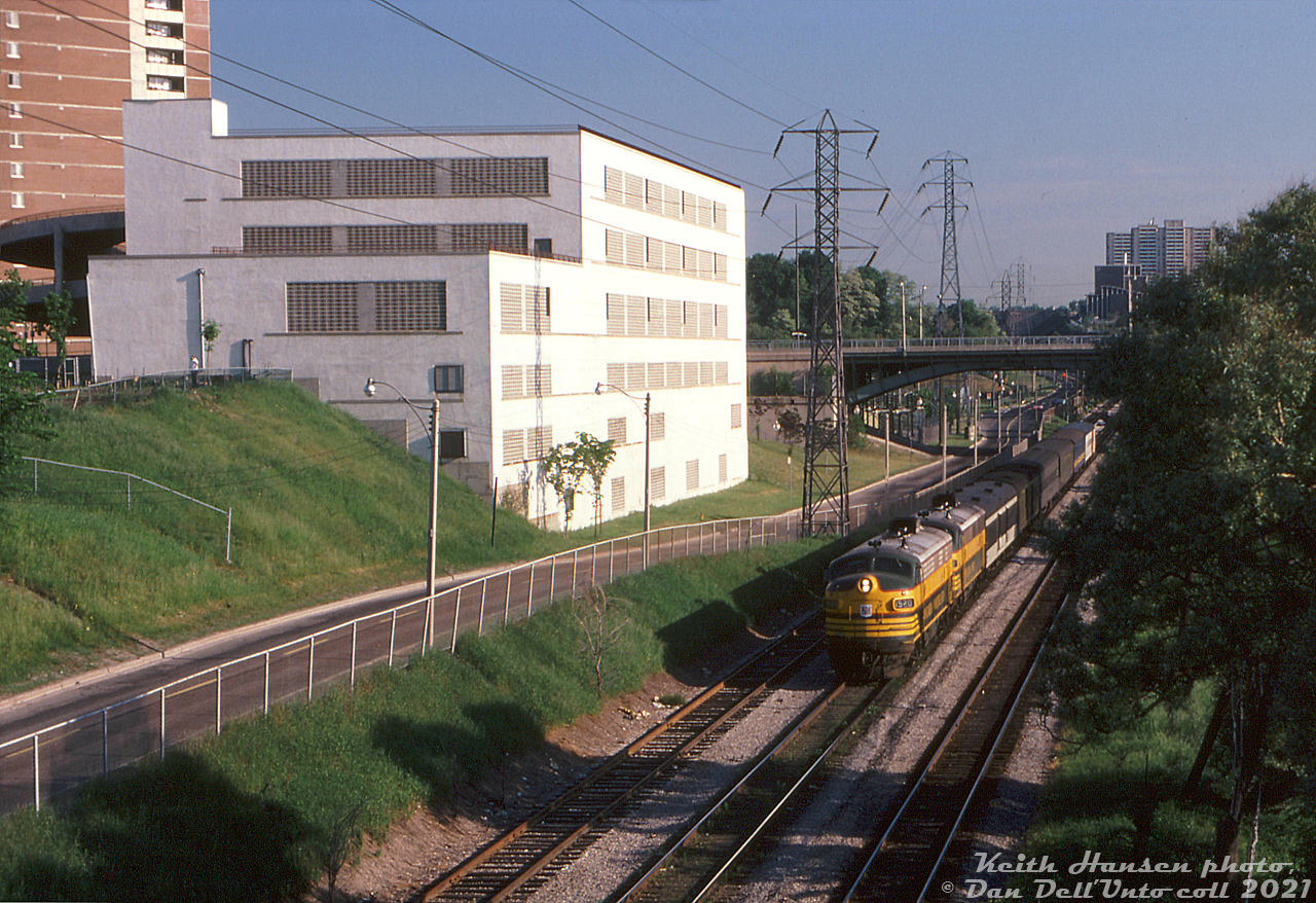 The southbound "Northland" is on the final leg of its Kapuskasing-Toronto journey, making its way through the Don Valley into downtown Toronto in the morning. It's seen here from the Dundas Street East overpass (Gerrard in the background) about to enter Toronto Terminals Railway trackage off CN's Bala Sub, that runs parallel here to Bayview Avenue and the Don River. Two of ONR's 1500-series FP7 units, lead by 1520, head up the joint CN-ONR overnight passenger train. Tracks left to right are CN's P500 service track (leading to their old Cherry St. yards), the CN Bala Sub mainline, and CP's Don Branch (Belleville Sub).

Keith Hansen photo, Dan Dell'Unto collection slide.