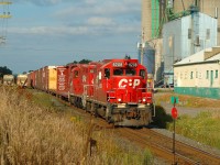 In 2004 I had a nice DSLR, an itch to scratch, and well, everything excited me. A rail grinder was coming ! Oh boy! So I beelined it for Ayr with enough time to catch the parade of westbounds that were before me. I simply parked here and snapped happily as these trains passed in great sunlight. <a href=http://www.railpictures.ca/?attachment_id=40054 target=_blank>First was an auto train at 4:25 PM with a great leader</a> then came this, at 5:53 PM, the Ham Turn, which I believe was train 525. The 'ham turn' ran from London to Hamilton and back and it's main purpose was to bring autoracks from Toyota east then south to connections in Hamilton for Buffalo, returning the other way in the afternoon. I would often find the Ham Turn in Galt lifting around 0830 and I think even then that was a late train. Going back north/west they usually had a very small train (to no train at all) with some parts cars for TDS in Tillsonburg that were handed off to the OSR and they do seem to be on the head end today, but looks like they also lifted some autoracks in Galt too. They also worked occasional customers especially those that were only served by 4 axle power such as the Ayr pit spur, Phillips & Daughters in Puslinch amongst others. The other local on the line(London Pickup) had 6 axle power at the time and it's job was to bring Toyota traffic to London from Galt to be lifted by other mainline trains, and with six axle power on the Pickup they couldn't work too many customers, hence Ham Turn did the rest. The Galt traffic came from the twice daily Galt job that worked to Toyota and back from Galt proper. In the evenings, Trains 127, 129, 139, 147 with auto traffic to or from from Oshawa, Brampton, Windsor, and Toyota lifted the auto traffic in London. All of this has since been consolidated into the current "London Pickup" and 2 Wolverton jobs, with all set offs and lifting done in Wolverton instead. Train 147 now handles almost all automotive traffic instead of the four trains that did so previously. 254 and 255 handle all the Buffalo connections now, but what we'd give to see this again today eh.
<br><br>
What about the rail grinder? - yet to come. :) 
