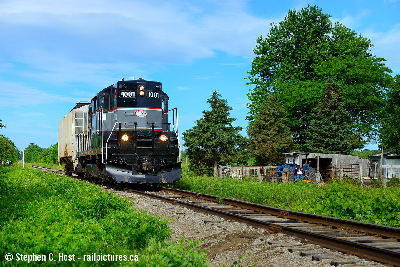 What can be more bucolic than a diminutive train passing a small farm in essa township, as the Barrie-Collingwood Railway traverses the former CNR Meaford subdivision with a single car in tow.