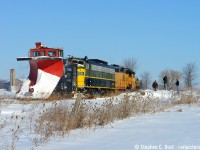 A blast from the recent past (literally) as an OSR plow extra reverses to make a 2'nd pass on a peksy drift on the St. Thomas sub. Watching are a gaggle of photographers, including James (Jim) A. Brown (centre). While I don't have the full story, Jim had a long career in the Railroad industry and is a <a href=http://ianwilsonauthor.com/blog/jab-obit target=_blank>noted photographer in our circles.</a> Before retirement he was the General Manager of the Waterloo-St Jacobs railway and was instrumental in getting the F units for that operation. WSJR was forced into Bankruptcy around 1999, and after over a decade the affairs were settled, whether Jim arranged/nudged it or not, 6508 was OSR's first F unit acquisition in 2013 with the other going to a museum out west. In a private ceremony yesterday witnessed by his family and friends, OSR 6508 now carries Jim's name, and took a tour of the OSR in his memory. <a href=http://www.railpictures.ca/?attachment_id=47179 target=_blank>(Next photo).</a>