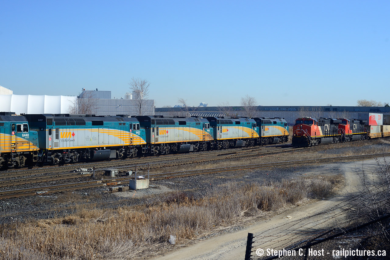 A meet at Snider West as VIA 11, equipment move to Vancouver with *five* F40's in the lead waits to reverse to the York Sub off the Newmarket connecting track. 11 would be reversing not too long after this shot was taken, and you can now sense our nervousness, the CN intermodal train might just block us entirely from the shot on this beautiful March day. After biting our nails and pacing a bit in excitement, we'd actually still get the shot, despite the westward reverse move happening with a CN freight blocking our view, we'd get the VIA's eastbound movement just moments after the tail end of the freight passed, and we'd also go home with this meet shot which would have been impossible otherwiseHere's Steve Bradley's beautiful view of the same train from Parry Sound.