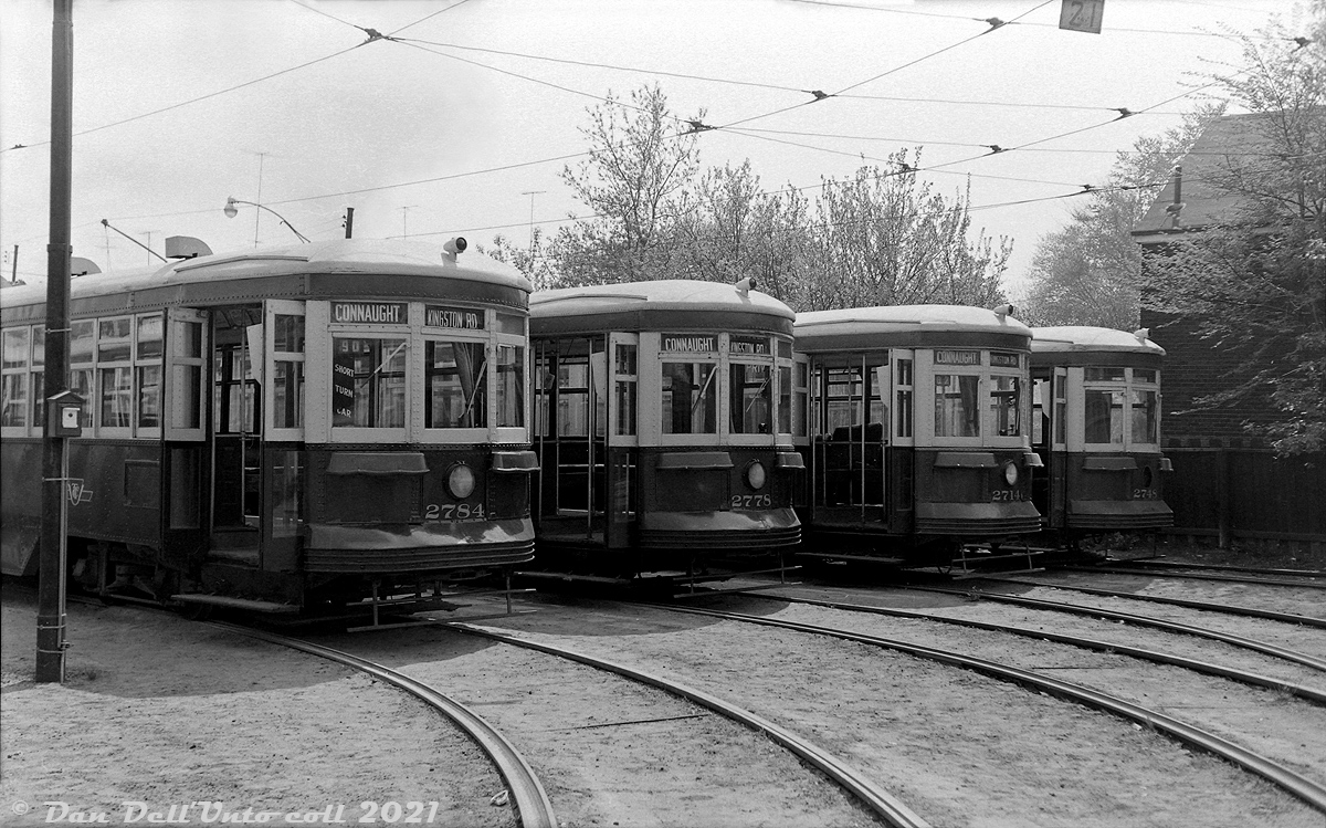 TTC Peter Witt streetcars 2784, 2778, 2714 and 2748 sit in the yard at Russell Carhouse off Queen Street during May 1962, waiting their next call to duty. Most appear to have come off Kingston Road streetcar runs, short-turning or going out of service at Connaught Avenue near the carhouse. One, 2748 parked on the far track of the yard, appears to have carried its last passenger as it's missing its front headlight and rollsigns.Overshadowed by more modern PCC streetcars, by this time the old 1920's Peter Witt fleet was not long for this world. The elimination of the Dupont streetcar route that ran on Bay Street the following year (replaced by the new University subway line in February 1963) resulted in the remaining handful of cars being parked and seeing sparse use (often for extra runs, spares, fantrips, charters, etc) until the last one, 2766, was finally retired in June 1965. The TTC would retain and eventually overhaul 2766 for downtown Tour Tram service in the 1970's, and borrow or reacquire a few other cars to join it. Of the four pictured here, 2778 would be sent to Trolleyville in North Olmsted OH when the TTC was in the process of disposing of the last of its cars, and the others were likely sold for scrap.Original photographer unknown, Dan Dell'Unto collection negative.