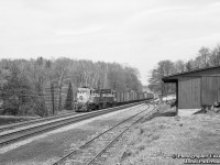 A pair of MLW RS18s, built in 1957, power extra 8739 west upgrade at Campbellville passing the stub track for Crawford Lumber and Fuel, seen at right, and the CPR freight shed, on the west side of Regional Road 1/Guelph Line. Date is approximate.<br><br>Originally built in 1889 as the Lewis Brother's Brick Works, the property would be purchased by Murray Crawford in 1900, who converted it into a sawmill, later expanding into fuels.  Much of the original mill burnt down in 1957, leaving just the coal sheds and office and warehouse buildings.  Today, these structures remain, though the loading dock seen above is gone.  The coal shed is now a furniture shop, Fine Oak Things, the office serves as Longhaul Logistics, a freight service, and the warehouse building is a Thai restaurant. 
 There is also a <a href=http://www.railpictures.ca/?attachment_id=35009>former CNR caboose 78337</a> on the property.<br><br>Lead unit 8739 would not see the rebuild program in the 1980s, having suffered a wreck at Bath, New Brunswick when hitting a washout about 0300h on April 1, 1976.  One crew member killed.  Parts were salvaged from the locomotive, however due to the difficulty of removing it, the loco was simply buried.  Trailing unit 8741 would be rebuilt in August 1984 to <a href=http://www.railpictures.ca/?attachment_id=15020>RS18u 1821</a> and retired from the CP in the mid 1990s.  1821 would be sold to the New Brunswick East Coast in April 1998, sold to CN with the NBEC/OCRR purchase in 2008, and sold again in 2009 to <a href=http://www.railpictures.ca/?attachment_id=10859>Le Massif de Charlevoix 1821.</a><br><br>Bill Thomson's shots from the freight shed, April 25, 1964:<br>CPR 21, "The Chicago Express", <a href=http://www.railpictures.ca/?attachment_id=36994>approaching the crossing.</a><br>CPR 21, <a href=http://www.railpictures.ca/?attachment_id=25072>head end passing freight shed.</a><br>The tail end for <a href=http://www.railpictures.ca/?attachment_id=25358>the final time.</a><br><br><i>Original Photographer Unknown, Jacob Patterson Collection Negative.</i>