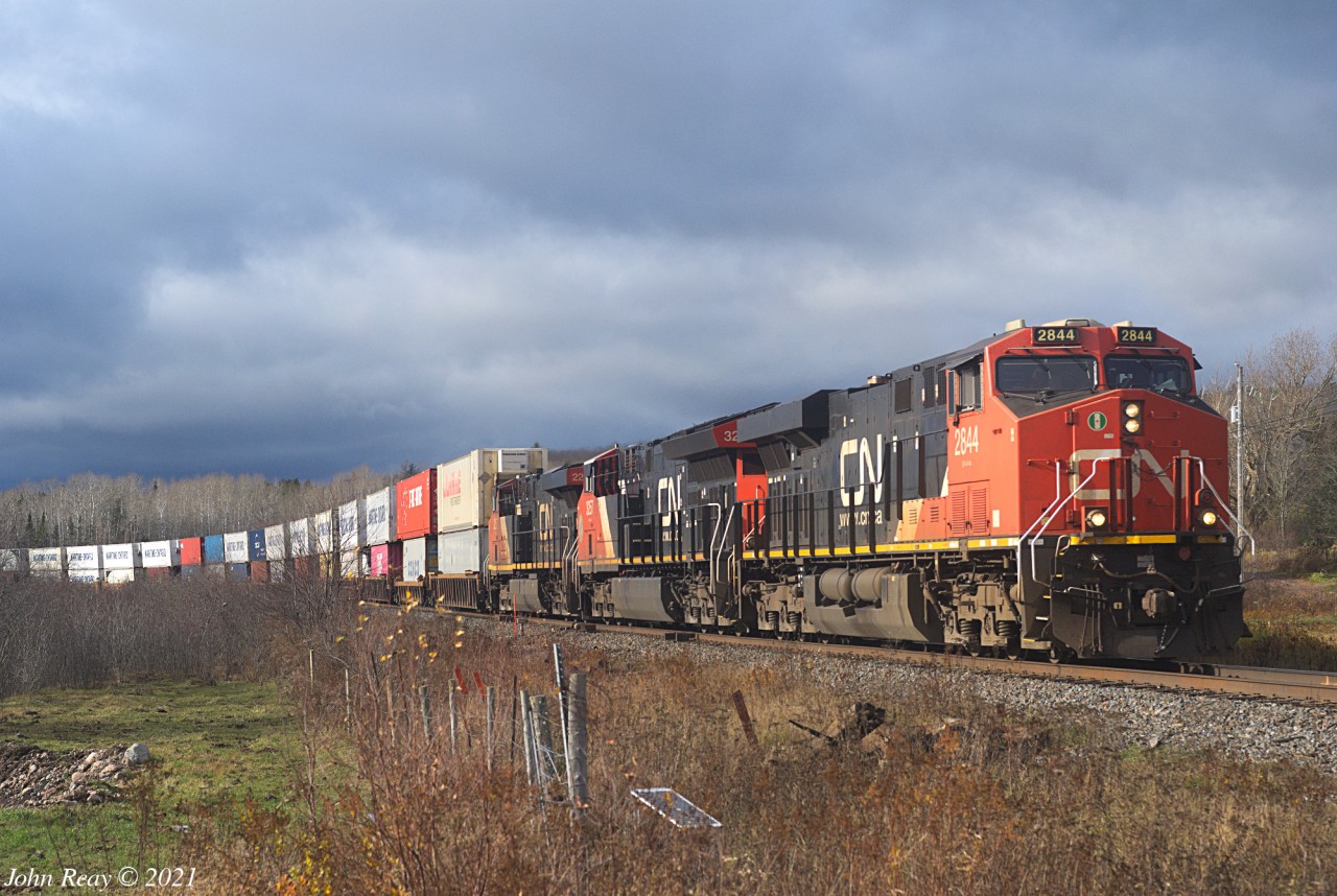 Nov 14th 2021 @ 14:16 AT, Z120 at MP 42.5 CN Springhill sub (Thomson Road). 634 axles with CN 2844, CN 3257 and CN 2257. The leaves are gone! I've been waiting for this as it reveals the containers rounding the curve to the west of the crossing. The curve looks a lot sharper in real life than it does on the map. As a bonus the sun appeared at the right time.