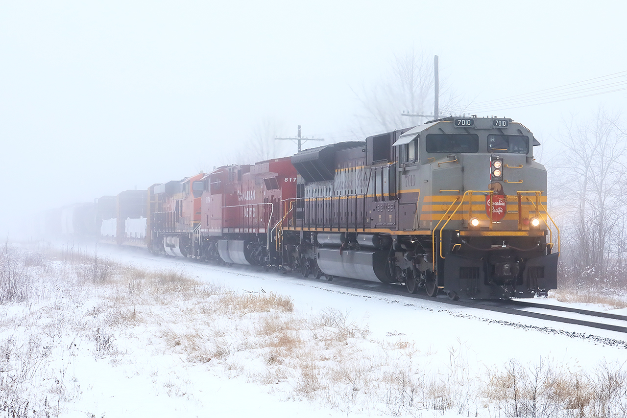 After a mysterious 36 hour stay in Detroit, 234 finally returned east, most importantly with 7010 still leading. The fog is thick and the air is heavy; heavy enough that you couldn't hear it whistling for a crossing only a mile away. But it near silence, as trains in the snow often are, 7010 east accelerates for its final 60 odd miles to a rest, and or hopefully, a quick turn home for the crew. Merry Christmas.