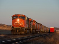 CN 401 is just about to take the light at the west end of Unity West in the last light of the day. The mile board to CP's Station Name Sigh Unity can be seen to the left of CN 5752. 