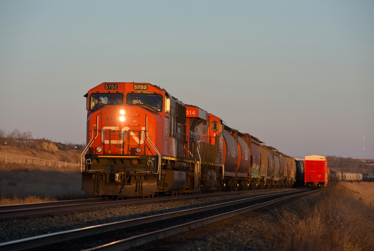 CN 401 is just about to take the light at the west end of Unity West in the last light of the day. The mile board to CP's Station Name Sigh Unity can be seen to the left of CN 5752.