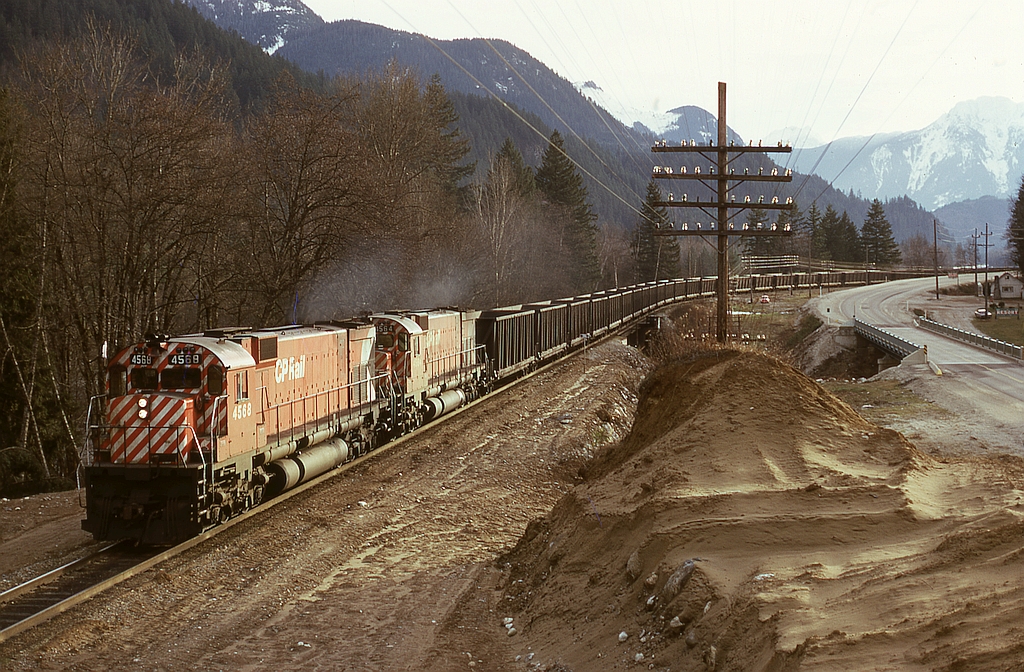 In the early years of coal train operation from southeast BC to Roberts Bank, CP MLW M-630s were regular power as they were the first CP units equipped with Locotrol, as illustrated here by 4568 and 4564 (with SD40-2 5641 and SD40 5552 and Robot car 1009 mid-train) handling coal empties eastward alongside the Trans Canada Highway and crossing Emory Creek.