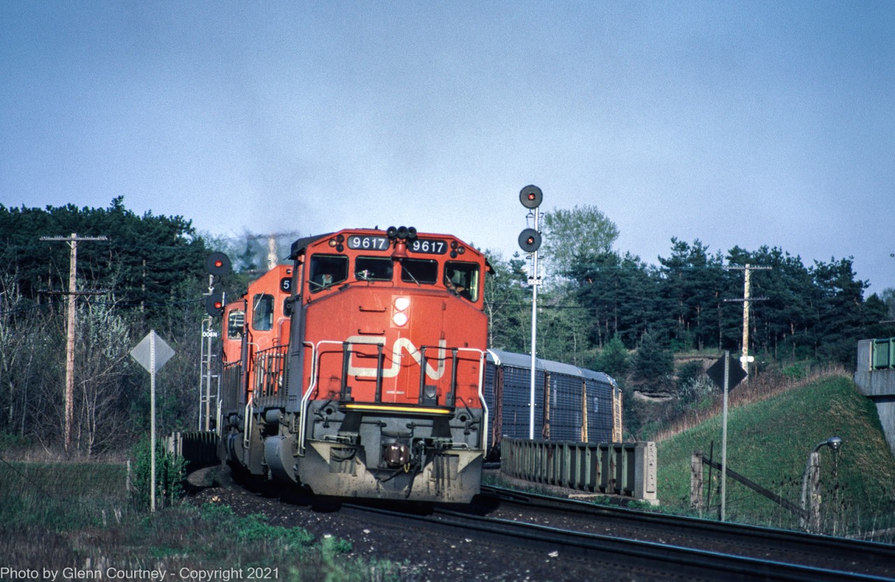 CN #413 is heading west on the Dundas Sub, beginning the climb up the Escarpment. It has just passed Hamilton West and is crossing over Highway 403.