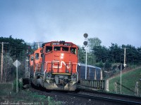 CN #413 is heading west on the Dundas Sub, beginning the climb up the Escarpment. It has just passed Hamilton West and is crossing over Highway 403. 