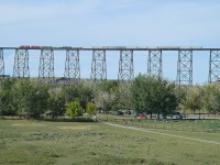 No one in the railfanning community on vacation goes by the Lethbridge Viaduct without checking it for trains. The landmark is almost a mile long and 300+ ft above the Oldman River. So, we were not going to leave town without checking it either. Waited an hour, but caught CP 6240 and 5049 heading west. What a sight!!
